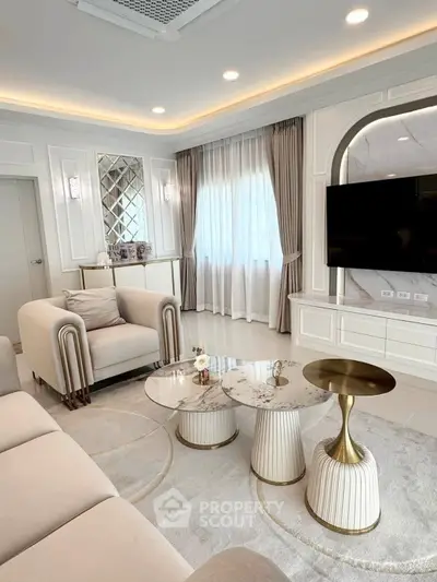 Luxurious living room with elegant decor, marble tables, and modern lighting, perfect for stylish living.