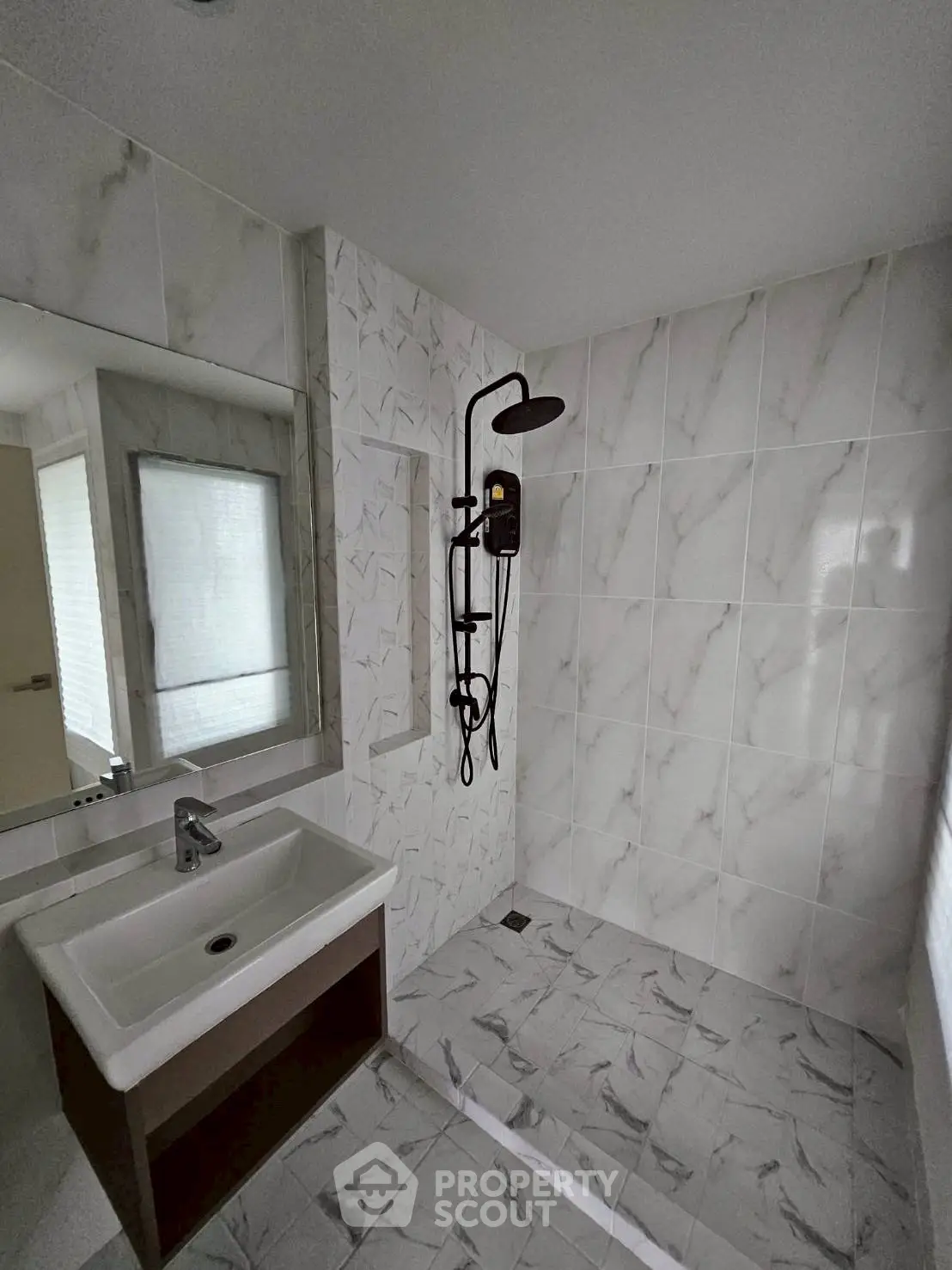 Modern bathroom with sleek shower and elegant marble tiles
