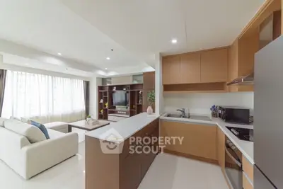 Spacious open-layout kitchen and living room with modern design and ample natural light.