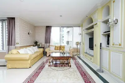 Luxurious living room with elegant decor, plush sofa, and large windows offering natural light.