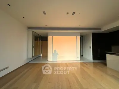 Spacious modern living room with wooden flooring and sleek design