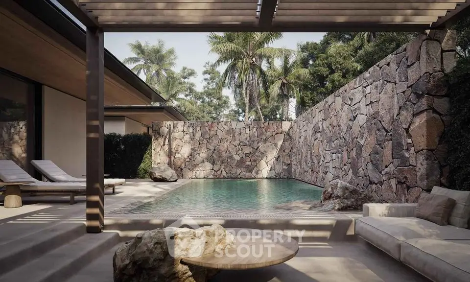 Luxurious private pool with stone wall and tropical landscaping