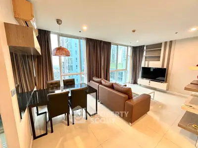 Spacious modern living room with large windows and city view, featuring elegant furniture and stylish decor.