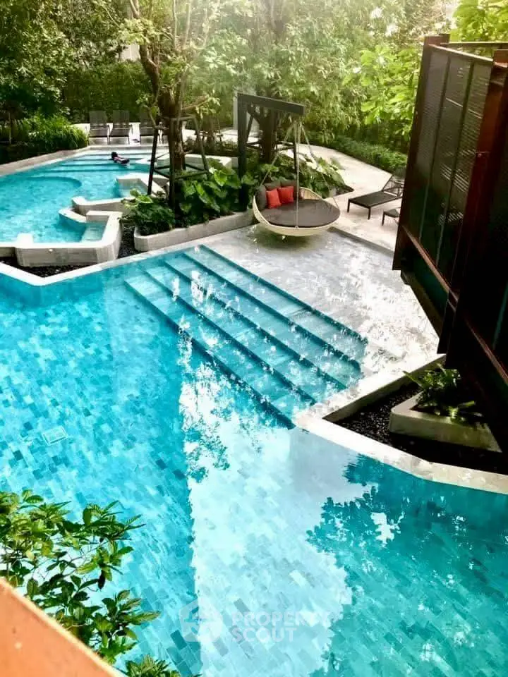 Luxurious outdoor pool with lush greenery and modern design, perfect for relaxation and leisure.