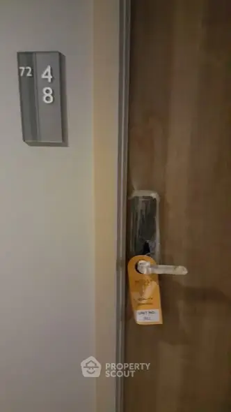 Modern apartment door with room number and electronic lock