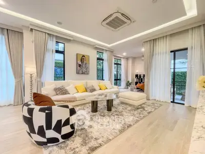 Luxurious modern living room with stylish decor and large windows offering natural light.