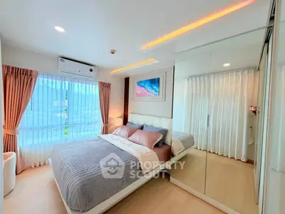 Modern bedroom with large windows and mirrored closet in a stylish apartment.