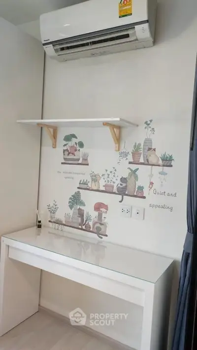 Cozy study nook with air conditioning and charming wall decor