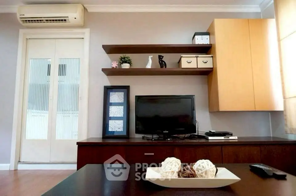 Modern living room with sleek TV setup and stylish shelving