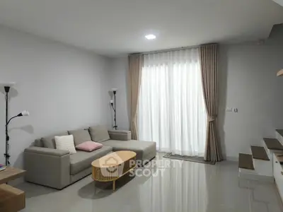 Modern living room with cozy sofa and elegant curtains in a stylish home interior.