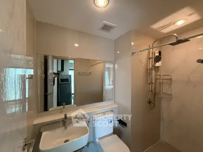 Modern bathroom with sleek fixtures and spacious shower area