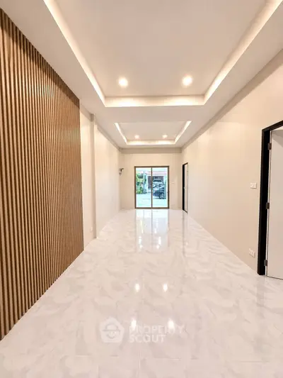 Spacious modern living room with elegant lighting and sleek flooring