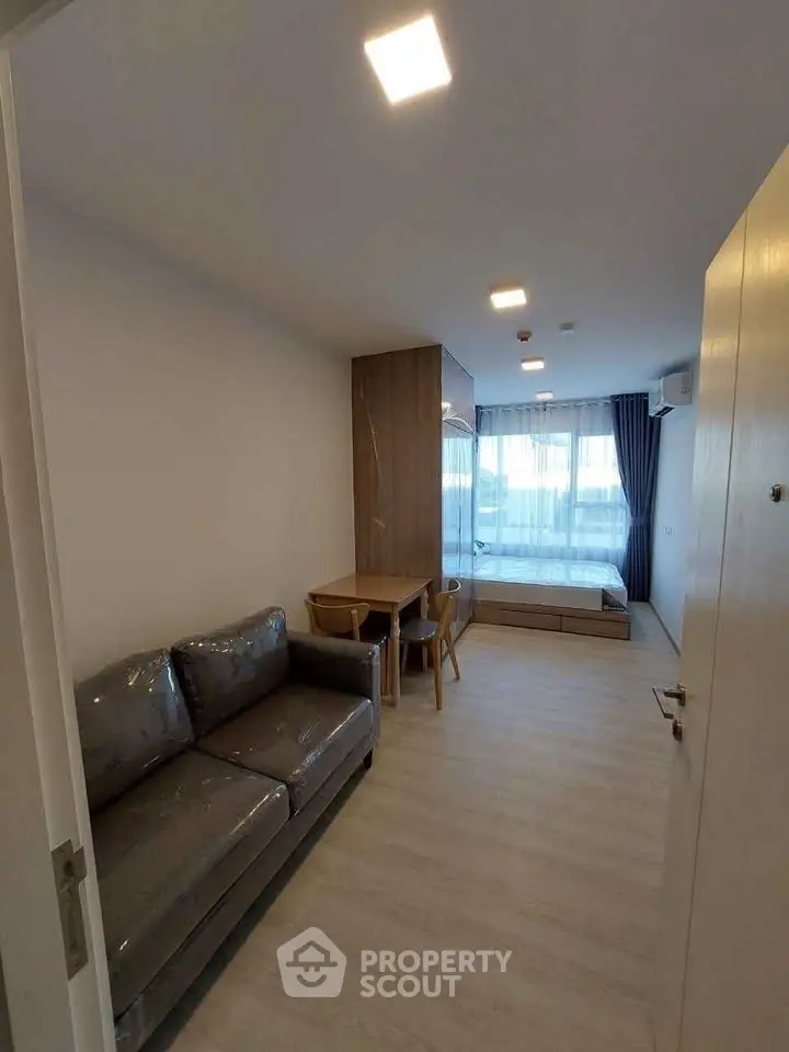 Modern living room with sleek furniture and large window for natural light