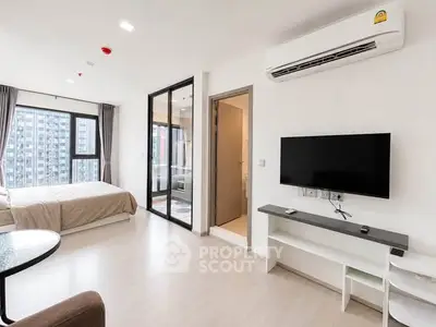 Modern studio apartment with open layout, featuring a cozy bedroom and sleek living area.
