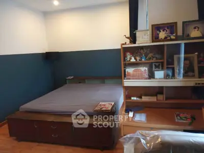 Cozy bedroom with wooden furniture and decorative shelf