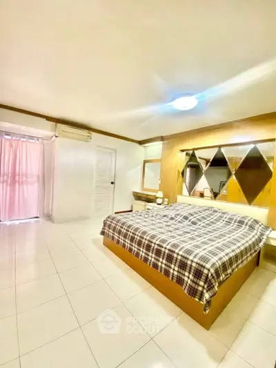 Spacious bedroom with modern design and ample natural light