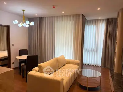 Modern living room with elegant lighting and cozy seating in a stylish apartment.
