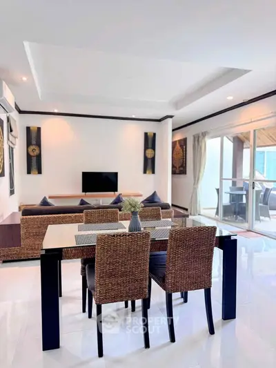 Spacious modern living room with elegant dining area and large windows for natural light.