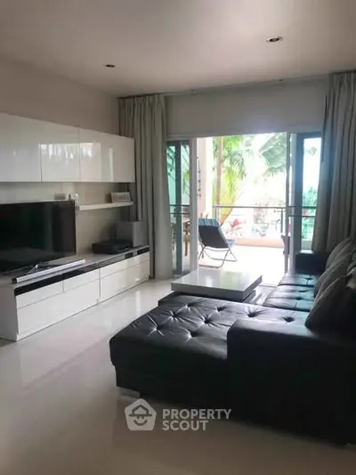Modern living room with sleek furniture and balcony view