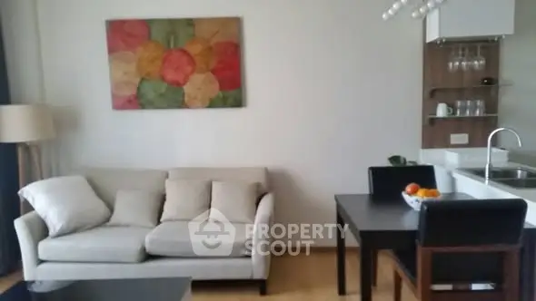 Modern living room with cozy sofa and dining area in open layout apartment.