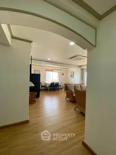 Spacious open-plan living room with elegant dining area and cozy seating.