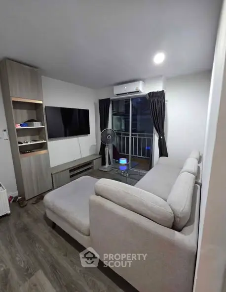 Modern living room with cozy sofa and balcony view