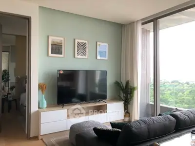 Modern living room with large TV and scenic window view