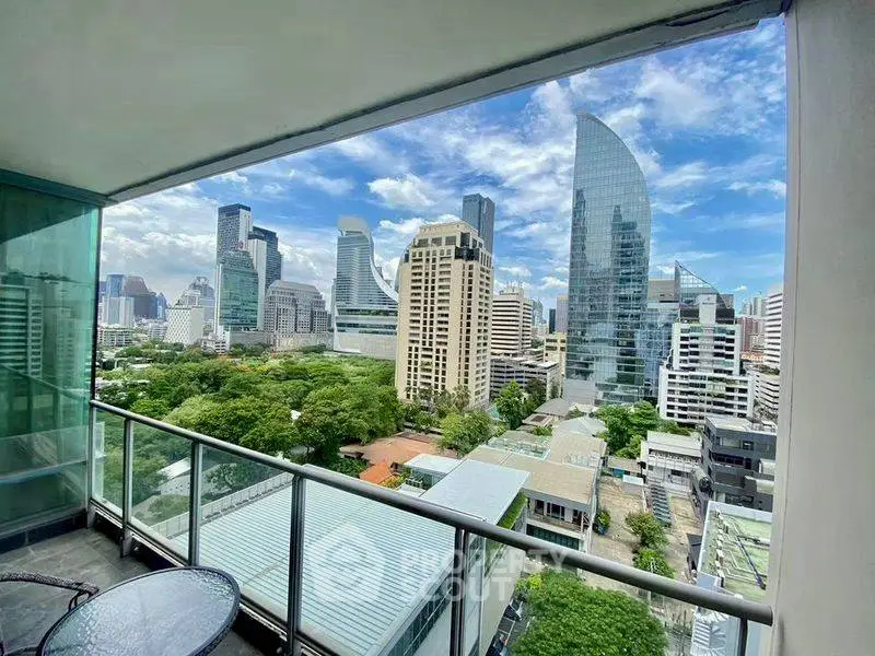 Stunning cityscape view from a modern balcony in a high-rise apartment.