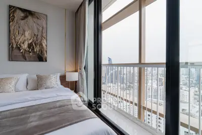 Luxurious bedroom with stunning city view from high-rise balcony