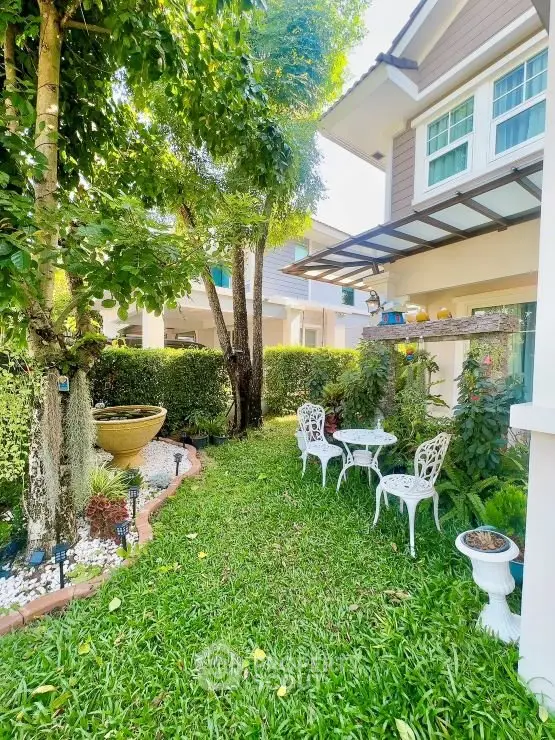 Charming garden with elegant outdoor seating in a beautiful residential property