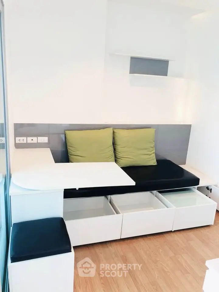 Modern living room with sleek built-in storage and stylish seating area.