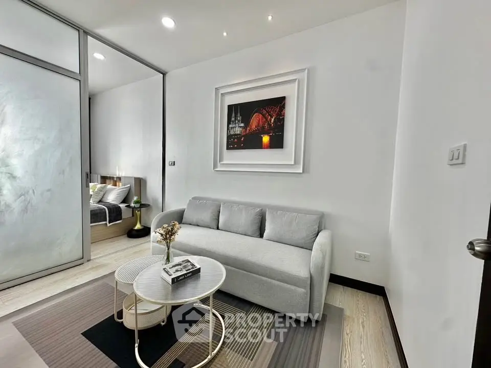 Modern living room with stylish decor and cozy ambiance, featuring a comfortable sofa and elegant artwork.