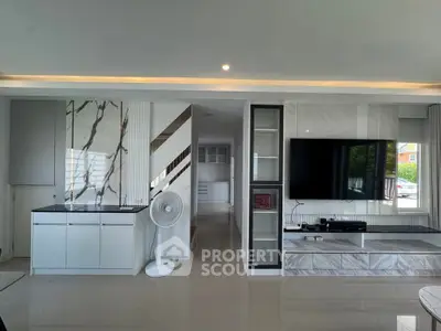 Modern living room with sleek marble accents and large TV setup