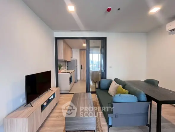 Modern living room with open kitchen and stylish furniture in a cozy apartment.