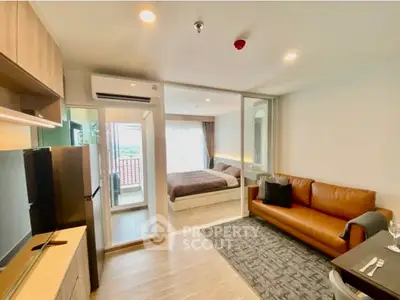 Modern open-plan living room with cozy bedroom and balcony view