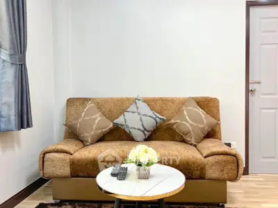 Cozy living room with stylish sofa and elegant decor, perfect for relaxation and comfort.