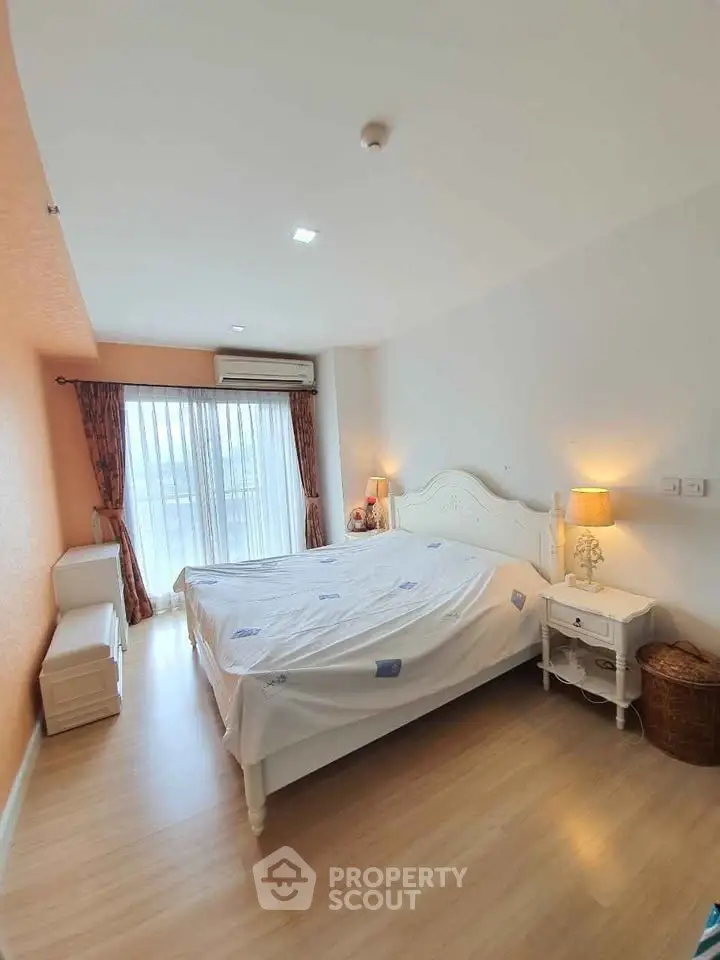 Spacious bedroom with elegant decor and natural light