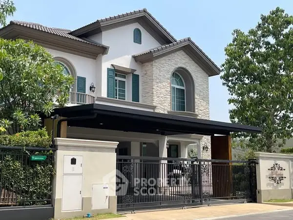 Elegant two-story house with modern facade and lush greenery