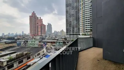 Stunning urban balcony view with city skyline and modern high-rise buildings.