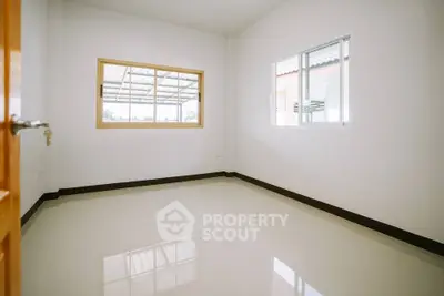 Bright empty room with large windows and glossy floor tiles