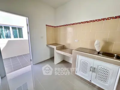 Modern kitchen with open layout and tiled backsplash in bright apartment