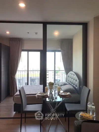 Modern studio apartment with glass partition and cozy dining area