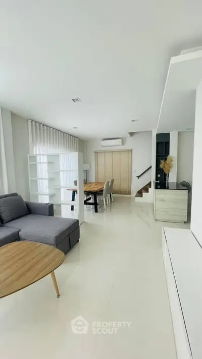Spacious modern living room with sleek furniture and open layout, perfect for contemporary living.