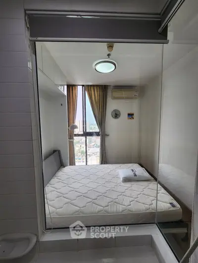 Modern bedroom with glass wall and city view, featuring a cozy bed and stylish decor.