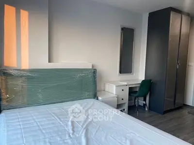 Spacious bedroom with large bed, modern furniture, and ample natural light, perfect for relaxation and comfort in a contemporary home.