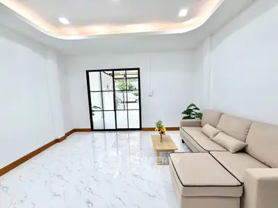 Spacious modern living room with elegant sofa and marble flooring