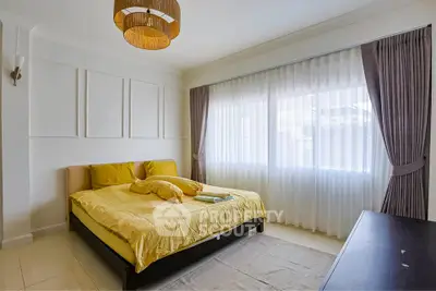 Bright bedroom with large window and stylish decor