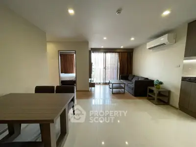 Modern living room with dining area and air conditioning in a stylish apartment.