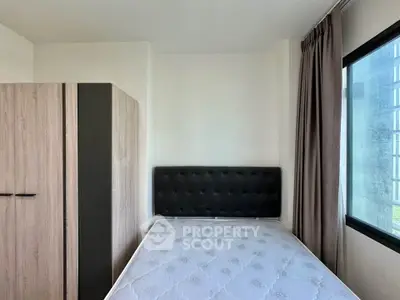 Modern bedroom with large window and stylish wardrobe, perfect for natural light lovers.