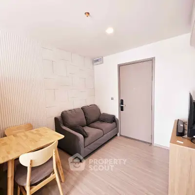 Cozy living room with modern decor and comfortable seating in a stylish apartment.